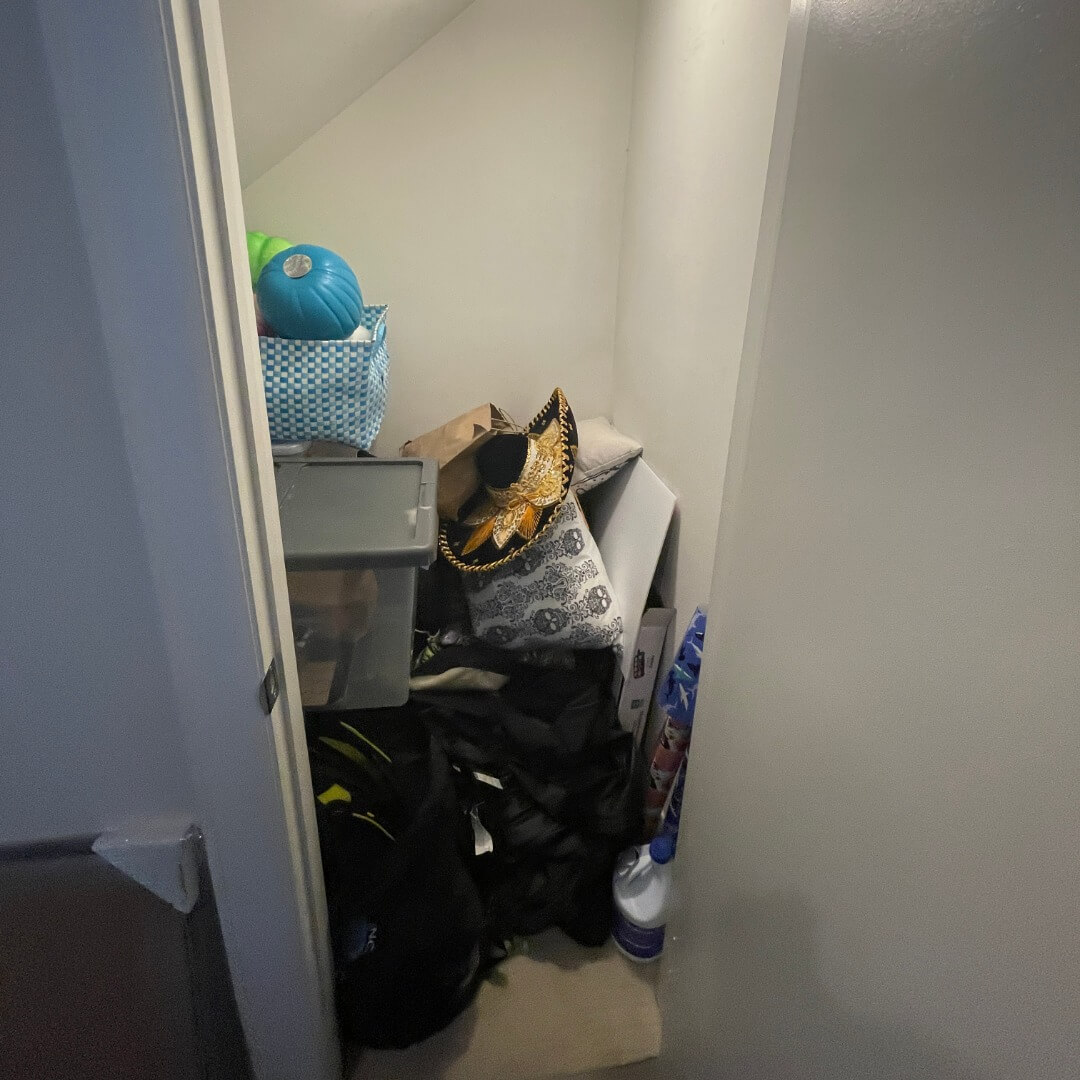 Cluttered Storage Room Under Staircase